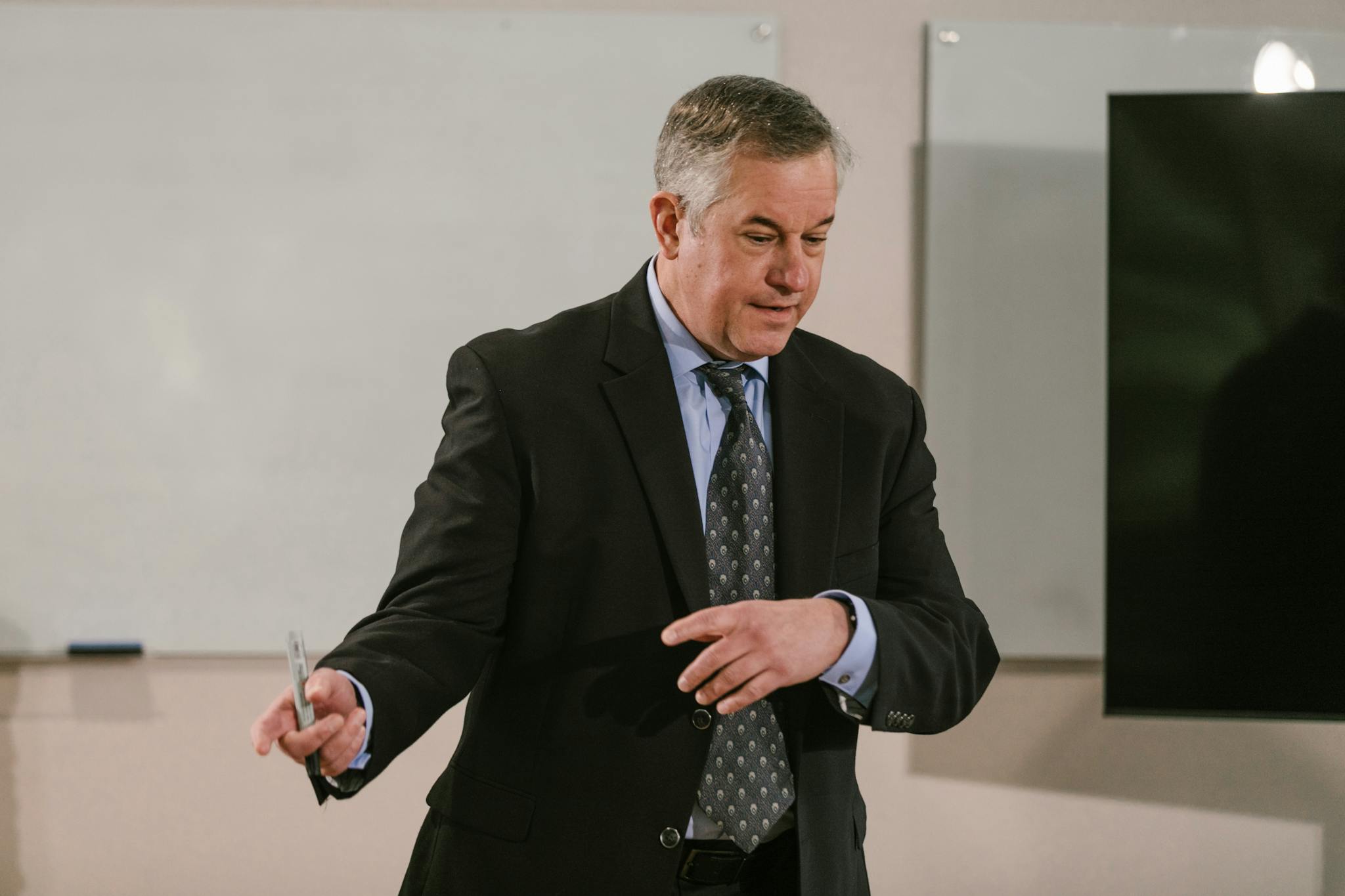 A business professional leading a presentation in a modern conference room.